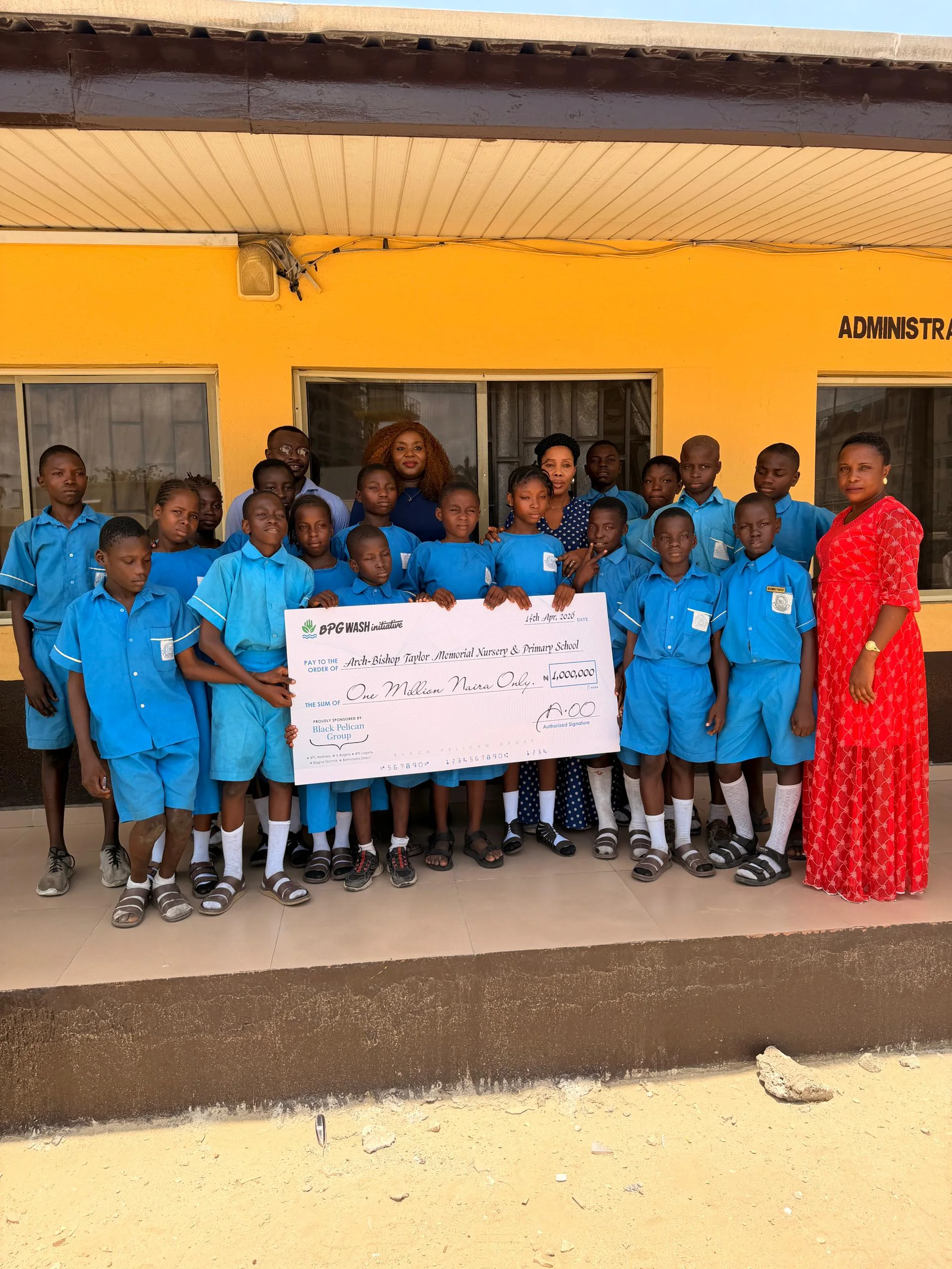 Black Pelican representatives with students at a school donation visit